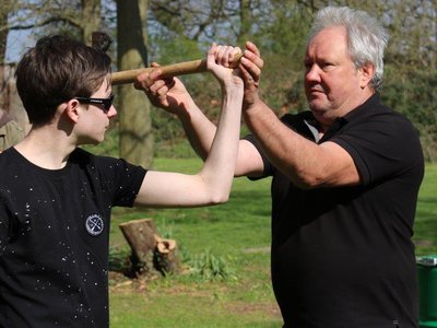 Teaching-the-Boy-How-Throwing-Axe-Works..jpg