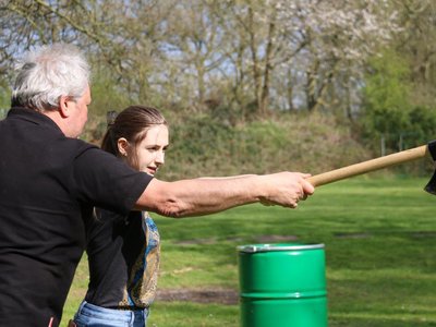 Teaching-the-Girl-How-Throwing-Axe-Works..jpg